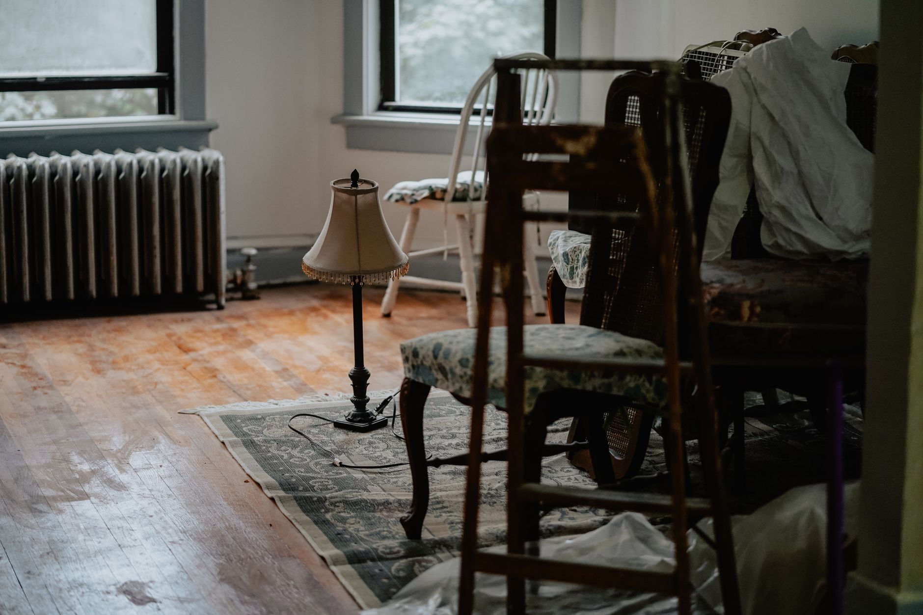 Cluttered room with furniture and belongings left behind after a tenancy